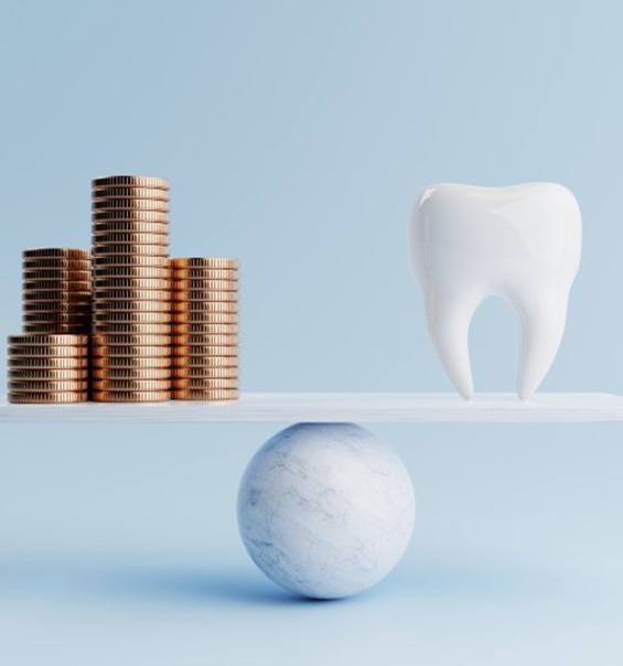 Tooth balanced against coins