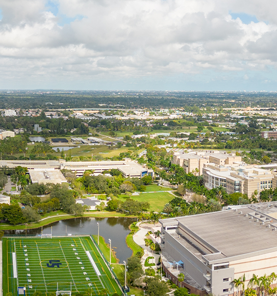 Aerial view of a football field and part of a university campus