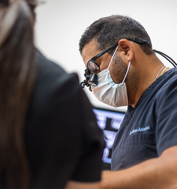 West Palm Beach dentist wearing dental binoculars while treating a patient