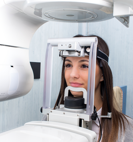 Woman receiving a cone beam scan of her mouth and jaw