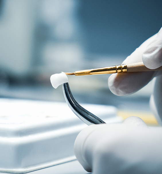 Ceramist crafting a dental crown