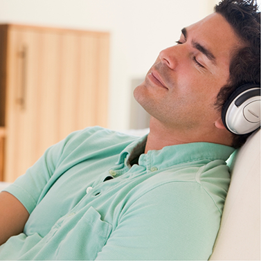 Man wearing headphones and relaxing with his eyes closed