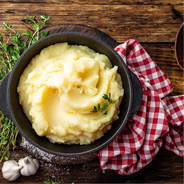 Bowl of mashed potatoes on table