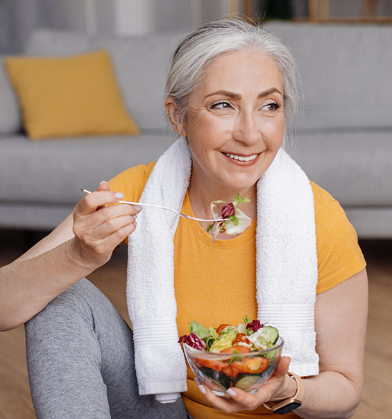 Senior woman eating a bowl of salad