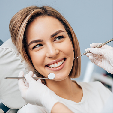 Woman smiling at her dentist during a dental checkup