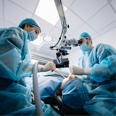 Two dental professionals performing a surgical procedure on a patient