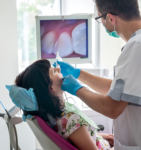 Dentist capturing photos of a patients teeth during a dental exam