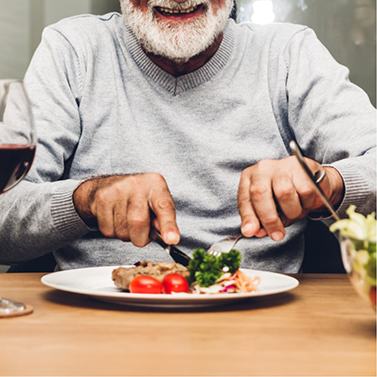 Man cutting vegetables on dinner plate