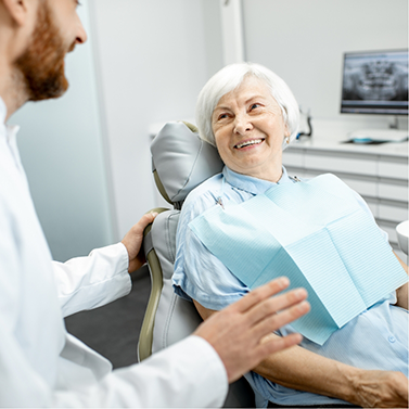 Senior dental patient listening to her dentist