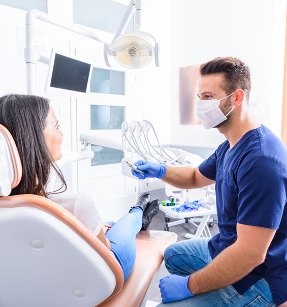 Dentist talking to woman in dental chair