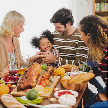 Family of four sitting at dinner table