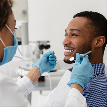 Man smiling at his dentist during a dental checkup