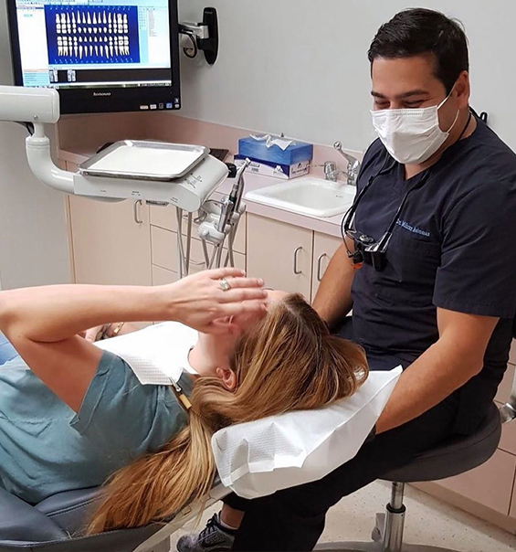 Dentist smiling at a patient before a full mouth reconstruction