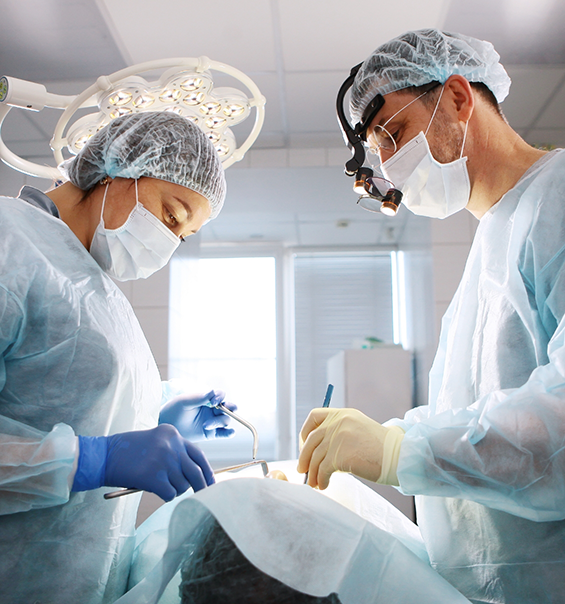 Dentist and assistant treating a patient