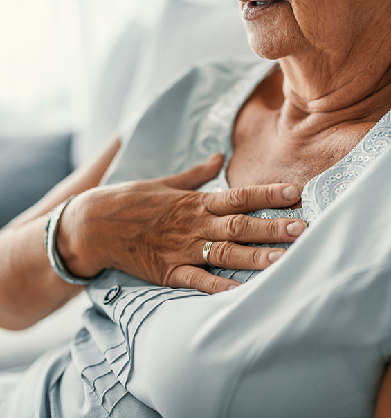 Close up of a senior person placing their hand over their heart