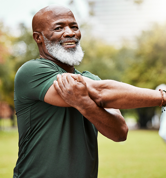 Senior man in athletic clothes stretching his arm