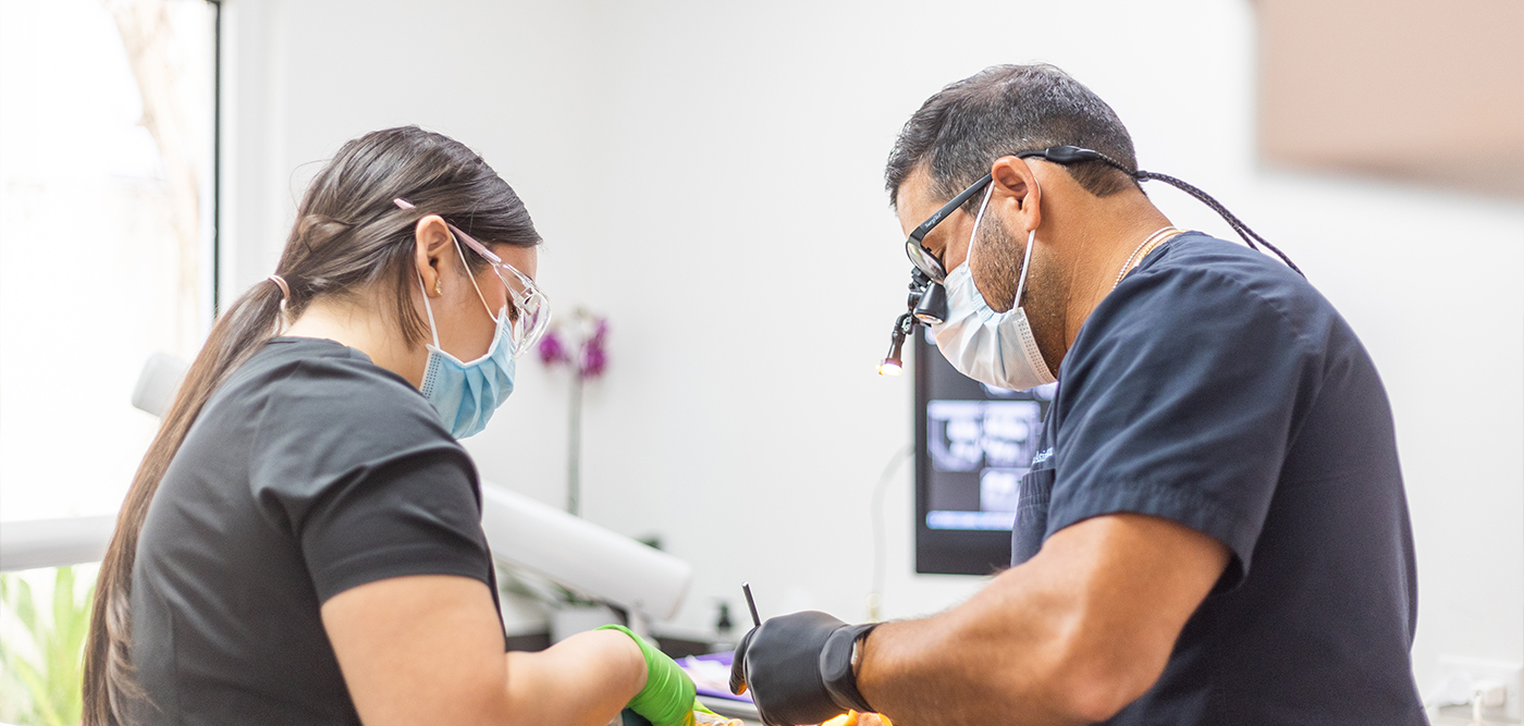 West Palm Beach dentist and assistant treating a patient