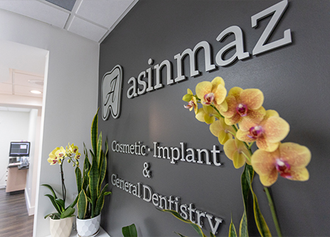 Sign on wall of dental office that reads Asinmaz cosmetic implant and general dentistry