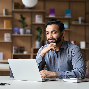 Man sitting at desk using laptop