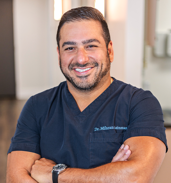 West Palm Beach dentist Doctor Mihran Asinmaz smiling with his arms crossed