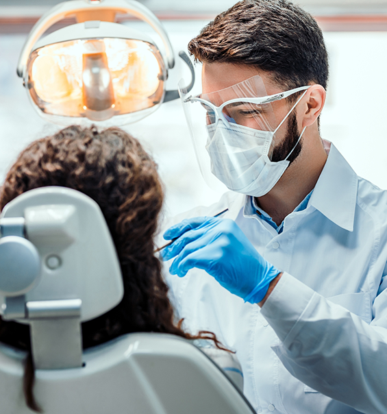 Woman having her mouth examined by her dentist