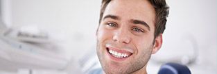 Young man sharing healthy happy smile after preventive dentistry visit