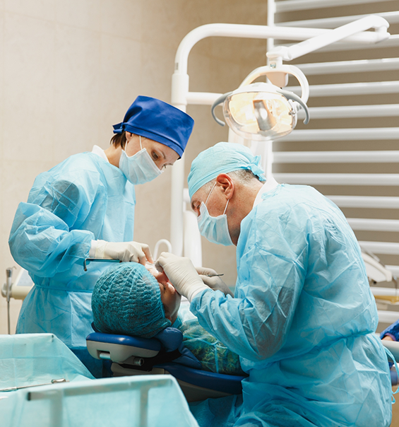 Dentist and assistant performing a procedure on a dental patient