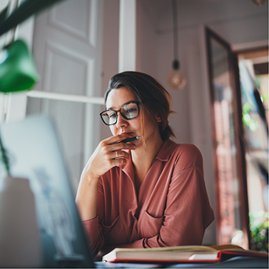 Woman looking pensive while using laptop