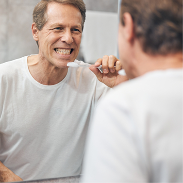 Man placing a whitening tray over his teeth