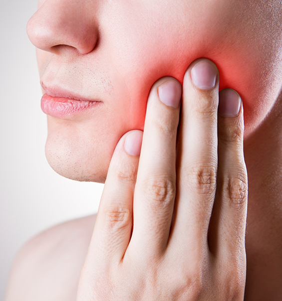 Person holding the side of their jaw in pain