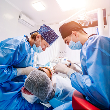 Dentist and assistant performing a dental procedure on a patient