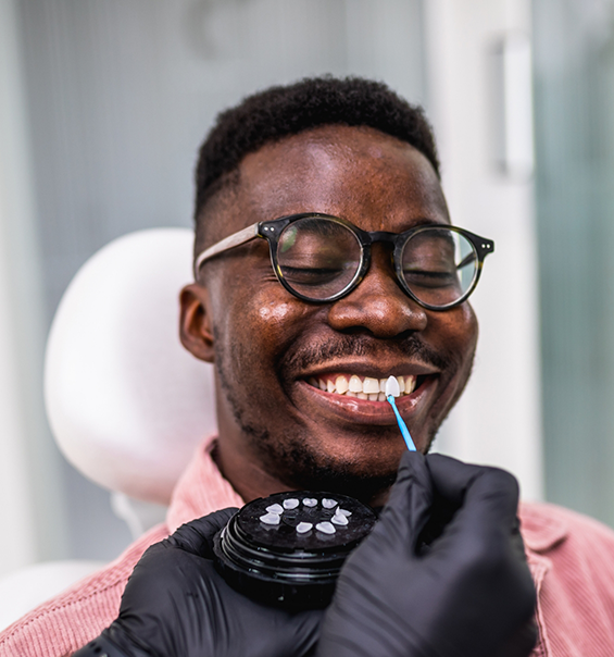 Dental patient smiling while being fitted for veneers in West Palm Beach