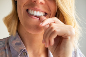 Close-up of woman putting on her Invisalign