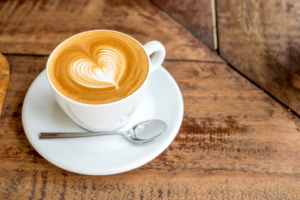 Close up of a cup of coffee with heart-shaped latte art